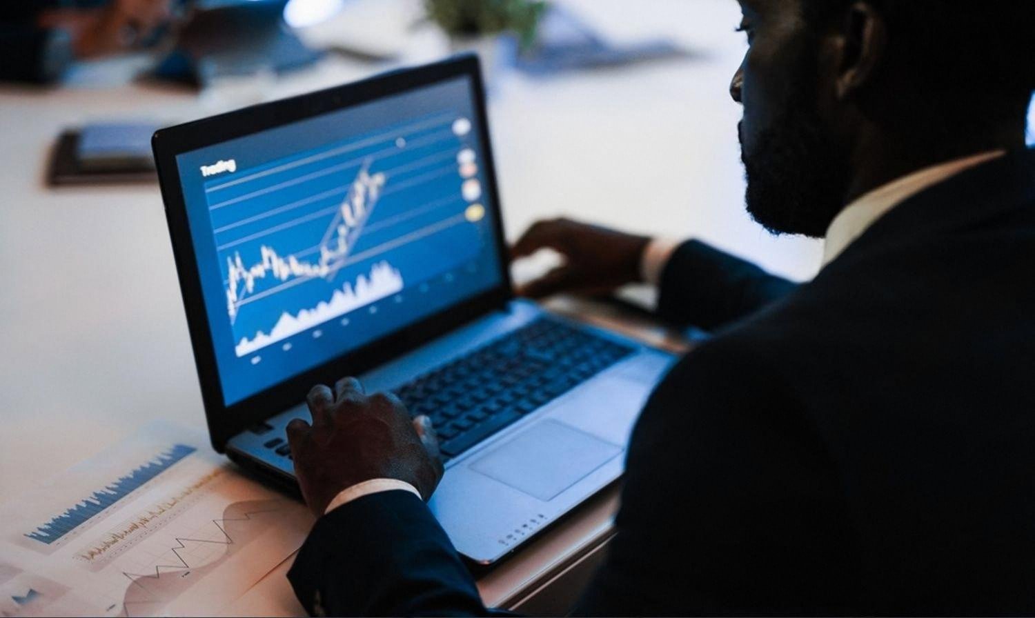Analyst reviewing financial risk data on a laptop in a UAE office